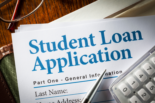 Student Loan Application with calculator and pen on top