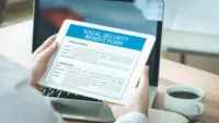 Person holding a Social Security Benefit Form considering their options in theses Social Security Case Studies.