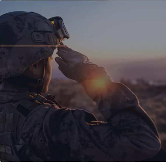 Person in combat uniform saluting