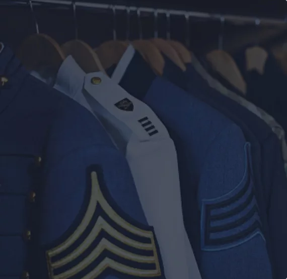 Old military uniforms hanging in a closet